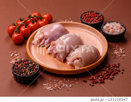 Raw chicken thigh fillet without skin and bone with salt and spices. Raw chicken fillet for cooking 131210547