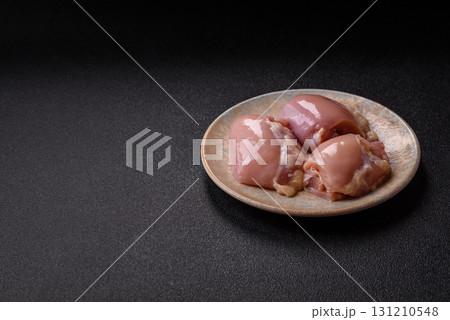 Raw chicken thigh fillet without skin and bone with salt and spices. Raw chicken fillet for cooking 131210548