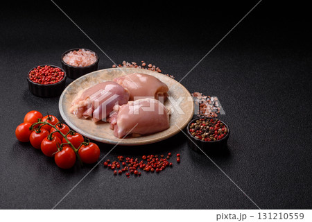 Raw chicken thigh fillet without skin and bone with salt and spices. Raw chicken fillet for cooking Raw chicken thigh fillet without skin and bone with salt and spices. Raw chicken fillet for cooking 131210559
