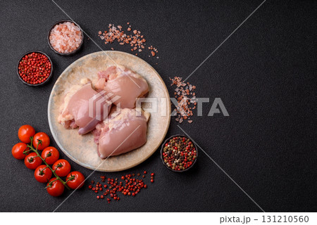 Raw chicken thigh fillet without skin and bone with salt and spices. Raw chicken fillet for cooking 131210560