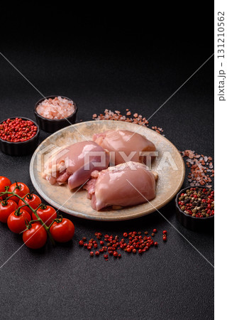 Raw chicken thigh fillet without skin and bone with salt and spices. Raw chicken fillet for cooking Raw chicken thigh fillet without skin and bone with salt and spices. Raw chicken fillet for cooking 131210562