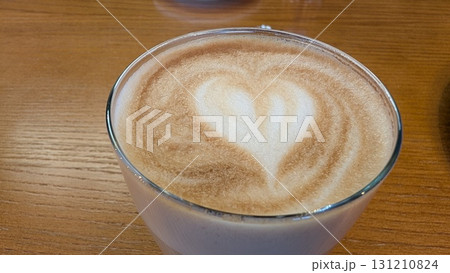 Indulging in Delightful Heartshaped Latte Art at a Cozy Cafe to Brighten Your Morning 131210824