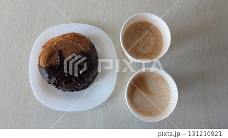 Indulge in a Delicious Chocolate Pastry served fresh with aromatic Coffee Cups for enjoyment Indulge in a Delicious Chocolate Pastry served fresh with aromatic Coffee Cups for enjoyment 131210921