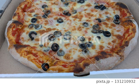Enjoy a delicious and satisfying Pizza topped with Olives and Cheese that everyone loves 131210932