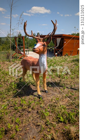 Realistic Deer Statue Amidst a Beautiful Natural Setting in an Idyllic Outdoor Environment Realistic Deer Statue Amidst a Beautiful Natural Setting in an Idyllic Outdoor Environment 131211025