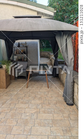 An Elegant and Stylish Outdoor Gazebo Complete with a Modern and Comfortable Furniture Setup An Elegant and Stylish Outdoor Gazebo Complete with a Modern and Comfortable Furniture Setup 131211028