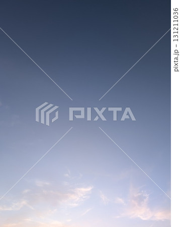 A stunningly beautiful blue sky adorned with soft clouds during dusk in the evening hours A stunningly beautiful blue sky adorned with soft clouds during dusk in the evening hours 131211036