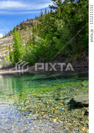 Scenic lake with clear green waters and the mountain with trees. 131211152