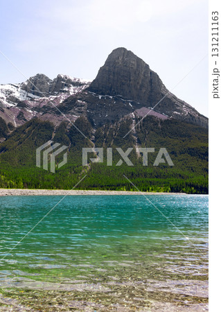Scenic lake with clear green waters and the mountain with trees. 131211163