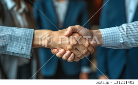 A man and woman shake hands in electric blue suit trousers at an event 131211402