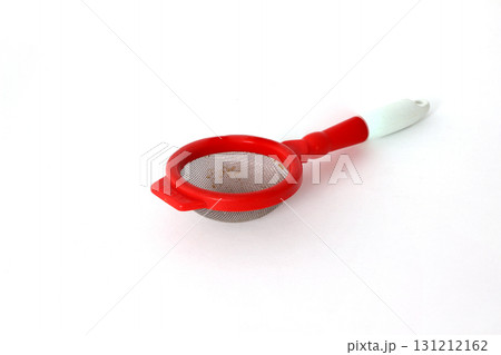 Red plastic tea strainer isolated on white background 131212162