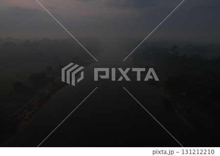 Misty river landscape at dawn with blurred surroundings and soft light 131212210