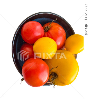 Ripe yellow and red tomatoes in a plate. 131212277