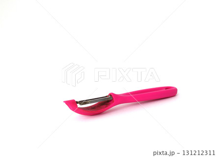 Pink vegetable peeler isolated on white background. Pink vegetable peeler isolated on white background. 131212311