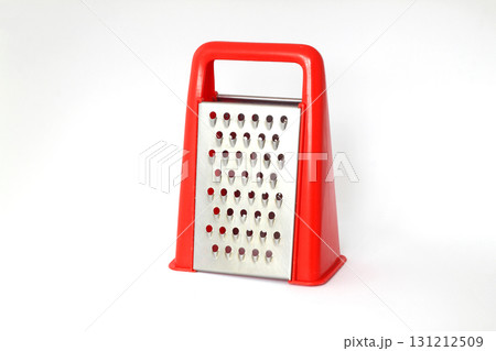Red grater stainless steel closeup isolated on white background. 131212509