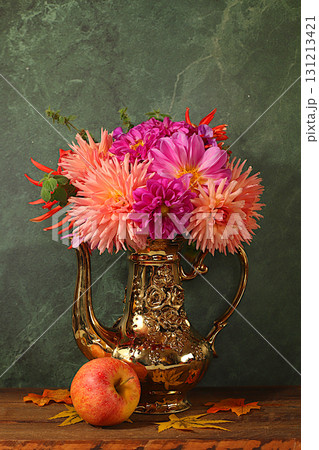 Autumn floral arrangement with dahlias in a vase, abstract still life with apples and flowers, Thanksgiving holiday banner, autumn greeting. Composition for a cozy mood 131213421