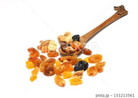 Mix of nuts and dried fruits in wooden spoon isolated on a white background. 131213561