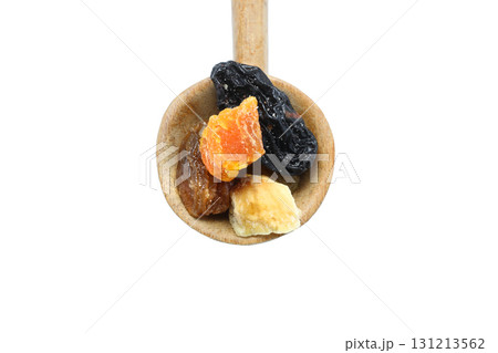Mix of nuts and dried fruits in wooden spoon isolated on a white background. 131213562