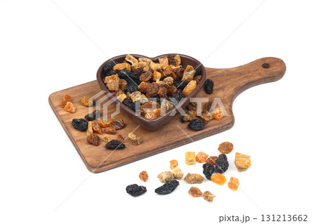 Mix of nuts and dried fruits in wooden bowl isolated on a white background. Mix of nuts and dried fruits in wooden bowl isolated on a white background. 131213662