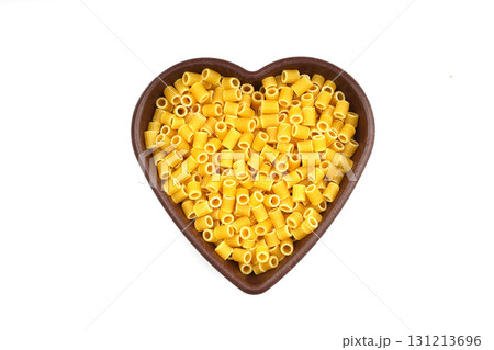 Pasta in the shape of a heart on a white background. 131213696