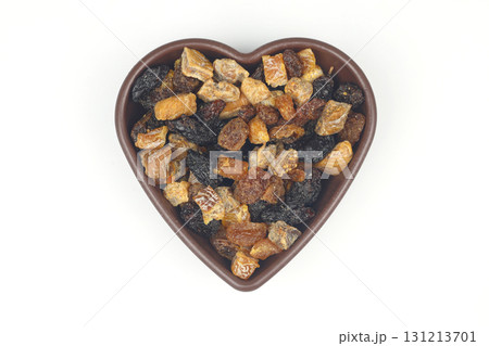 Mix of nuts and dried fruits in wooden bowl isolated on a white background. Mix of nuts and dried fruits in wooden bowl isolated on a white background. 131213701