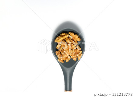 Peeled walnuts in wooden bowl isolated on white background. Top view. Peeled walnuts in wooden bowl isolated on white background. Top view. 131213778