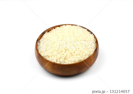 Raw white rice on wooden background. Long uncooked rice in wooden plate. Natural organic food. Traditional Asian cereal culture. 131214057