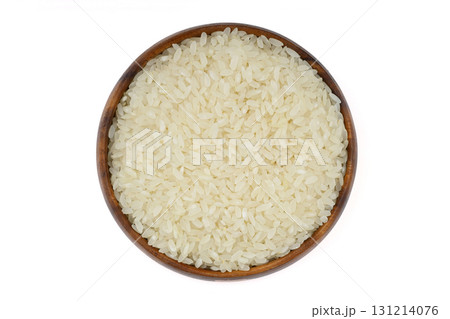 Raw white rice on wooden background. Long uncooked rice in wooden plate. Natural organic food. Traditional Asian cereal culture. 131214076