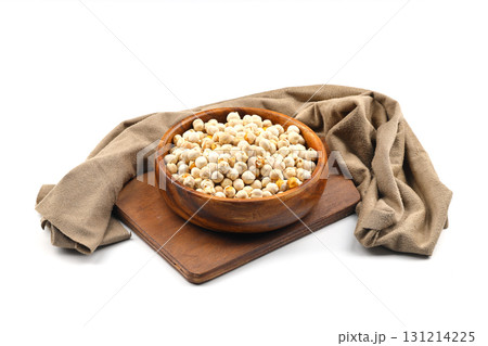 Roasted white chickpeas in wooden bowl on white background, top view. White chickpeas, with their high fiber content, are very healthy to consume. Roasted white chickpeas in wooden bowl on white background, top view. White chickpeas, with their high fiber content, are very healthy to consume. 131214225