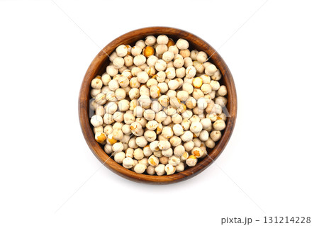 Roasted white chickpeas in wooden bowl on white background, top view. White chickpeas, with their high fiber content, are very healthy to consume. 131214228