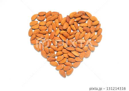 Almond heart on a white background. I love almonds. Healthy snack with nuts. Almond heart on a white background. I love almonds. Healthy snack with nuts. 131214316