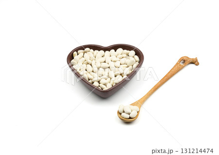 white kidney beans in a heart shaped bowl a on white background.Top view. 131214474