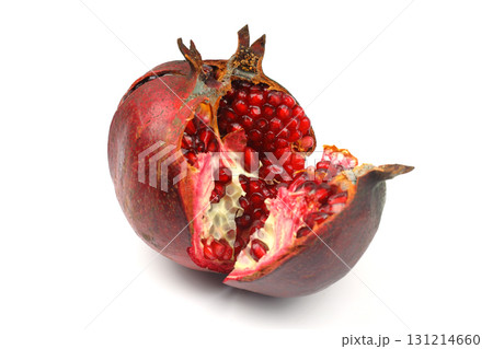 Ripe pomegranate fruit peeled on a white background top view close-up. Large open pomegranate fruit with large ripe grains isolated. Sliced exotic fruit. 131214660