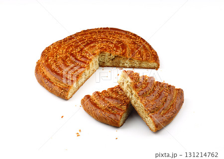 Slices of Ramadan Pita (Ramazan Pidesi) Traditional Turkish bread for holy month Ramadan on white background. Ramadan concept. 131214762