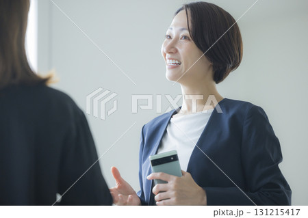 スマホを操作するスーツの女性 スマホを操作するスーツの女性 131215417