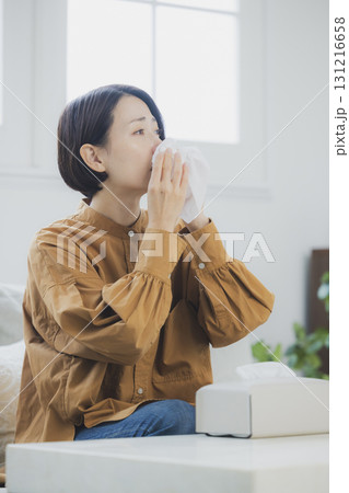 風邪をひいてマスクをつける女性 131216658