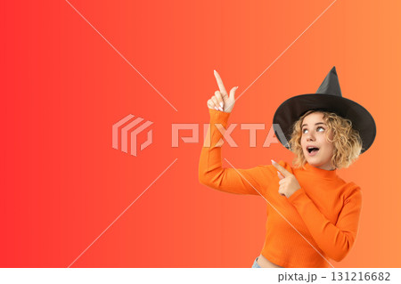 Young woman joyfully pointing in a festive Halloween setting Young woman joyfully pointing in a festive Halloween setting 131216682