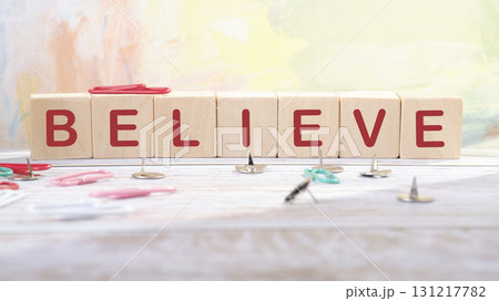 The concept word BELIEVE is made of wooden cubes on an abstract background. Business believe concept. Copy space 131217782