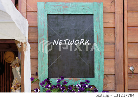 Cloud technology, upload and download concept. Copy space. NETWORK written on Charming wooden wall with a turquoise-framed chalkboard 131217794