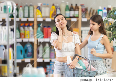 Tired mother and demanding daughter in supermarket cleaning aisle 131218247