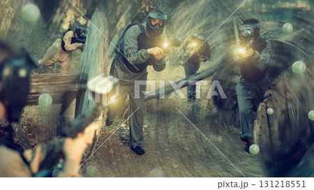 Teams facing on battlefield in outdoor paintball arena during match 131218551