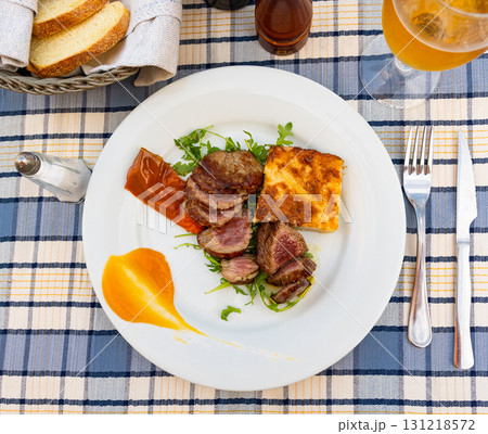 Italian steak with potatoes, peppers and arugula 131218572