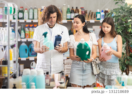 Interested family selecting household cleaning supplies in supermarket 131218689