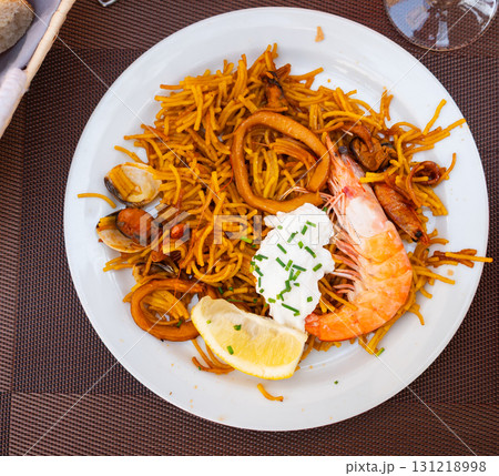 Pasta with seafood contains tiger prawns, shell mussels, spices and white sauce Pasta with seafood contains tiger prawns, shell mussels, spices and white sauce 131218998
