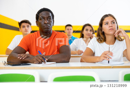 African American man and woman take a written exam in classroom African American man and woman take a written exam in classroom 131218999