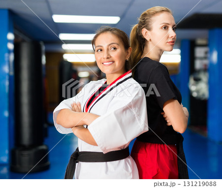 Portrait of two smiling sportswoman in karate uniform Portrait of two smiling sportswoman in karate uniform 131219088