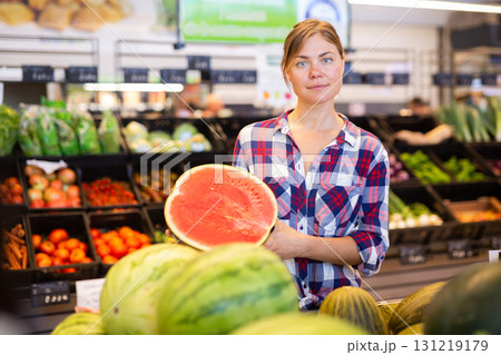 Portrait of woman with half of watermelon in supermarket Portrait of woman with half of watermelon in supermarket 131219179
