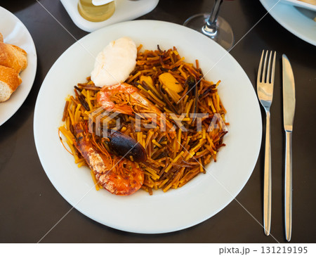 Fideua with seafood served on platter Fideua with seafood served on platter 131219195