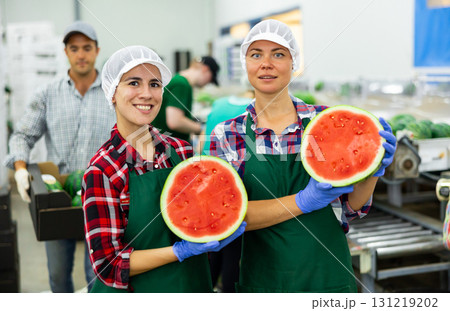 Portrait of positive women fruit factory worker with watermelon Portrait of positive women fruit factory worker with watermelon 131219202