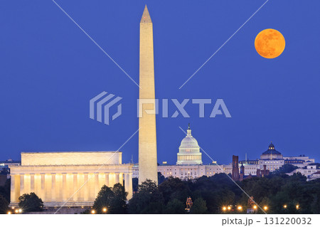 Washington DC skyline illuminated at dusk with Lincoln Memorial, Washington Monument and US Capitol, including a beautiful full orange moon on the background, USA Washington DC skyline illuminated at dusk with Lincoln Memorial, Washington Monument and US Capitol, including a beautiful full orange moon on the background, USA 131220032
